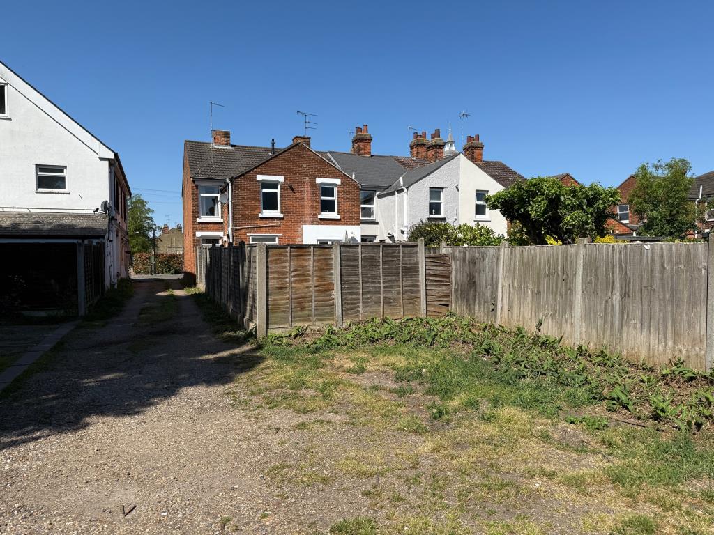 Lot: 116 - END-TERRACE HOUSE WITH PARKING - Parking area access road and rear elevation of the house